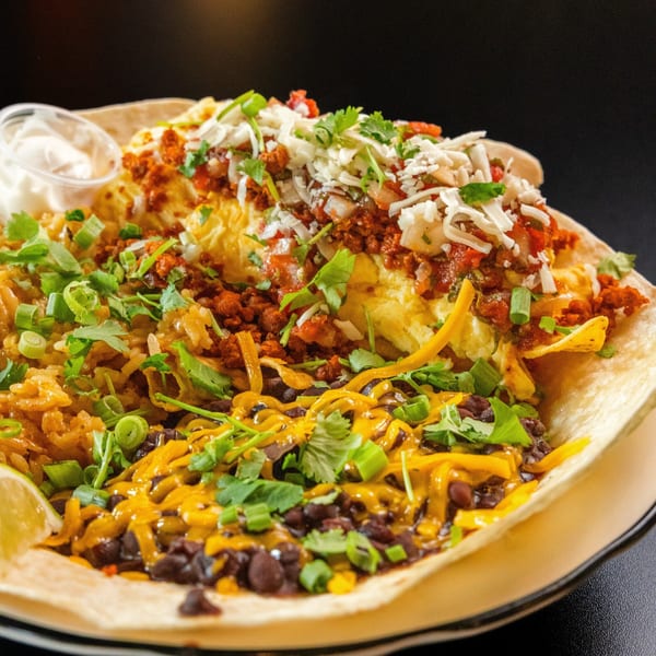 Sterling's breakfast burrito with scrambled eggs, chorizo, rice, black beans, cheese, and cilantro.
