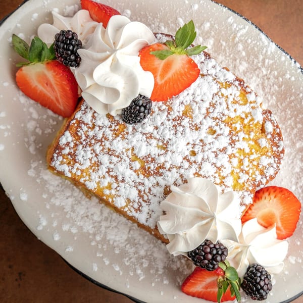 Sterling's French toast with powdered sugar, whipped cream, strawberries, and blackberries.